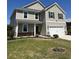 Charming two-story home boasting manicured lawn, two-car garage, black shutters, and welcoming front porch at 3059 Adventure Way, Ladson, SC 29456