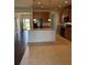 The kitchen has a functional island, stainless appliances, a view to the backyard, and transitions to hardwood floors at 3059 Adventure Way, Ladson, SC 29456
