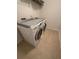 A compact laundry room features tile flooring and a modern washer and dryer set at 3059 Adventure Way, Ladson, SC 29456