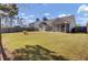 Expansive backyard featuring a well-manicured lawn, mature trees, and a sturdy wooden fence at 306 Slow Mill Dr, Goose Creek, SC 29445