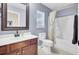 Full bathroom features tub/shower and vanity with warm wood cabinets at 306 Slow Mill Dr, Goose Creek, SC 29445