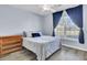 Cozy bedroom featuring a large window, wood flooring, and a ceiling fan for added comfort at 306 Slow Mill Dr, Goose Creek, SC 29445