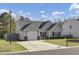 Charming single-Gathering home with a well-maintained lawn, attached garage, and inviting curb appeal on a sunny day at 306 Slow Mill Dr, Goose Creek, SC 29445