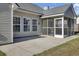 Back exterior view showcasing a screened-in porch, patio and a well-maintained yard at 306 Slow Mill Dr, Goose Creek, SC 29445
