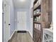 Hallway with hardwood floors, white doors, and custom wooden bookcase at 306 Slow Mill Dr, Goose Creek, SC 29445
