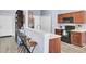 Open-concept kitchen with breakfast bar, dark cabinetry, and modern appliances at 306 Slow Mill Dr, Goose Creek, SC 29445
