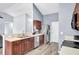 Open kitchen features stainless appliances, warm cabinets, and hardwood floors at 306 Slow Mill Dr, Goose Creek, SC 29445