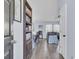 Spacious entryway leading to the living room, featuring hardwood floors and a stylish bookcase at 306 Slow Mill Dr, Goose Creek, SC 29445