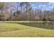 Beautiful backyard pond with grassy bank and natural surroundings, promising tranquility and privacy at 306 Slow Mill Dr, Goose Creek, SC 29445
