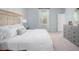 Bright bedroom featuring a large window, plush bedding, and neutral decor, creating a serene and inviting space at 313 Pine Crest View Dr, Summerville, SC 29486