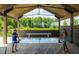 Outdoor recreational area with ping pong tables, wooden beams, and lush green landscaping at 339 Trailmore Ln, Summerville, SC 29486