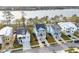 Aerial front view of neighborhood homes with driveways and landscaping against a waterfront at 384 Blowing Fresh Dr, Charleston, SC 29492