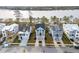 Aerial view of three waterfront homes highlighting landscaping, driveways, and walkways at 384 Blowing Fresh Dr, Charleston, SC 29492