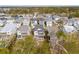 Aerial view of homes with screened in porches and balconies surrounded by mature trees at 384 Blowing Fresh Dr, Charleston, SC 29492