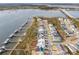 Stunning aerial view of waterfront homes with private docks on a scenic coastline, and a bridge in the distance at 384 Blowing Fresh Dr, Charleston, SC 29492