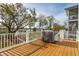 Relaxing back deck with a grill and waterfront views, perfect for outdoor entertaining and enjoying the serene scenery at 384 Blowing Fresh Dr, Charleston, SC 29492