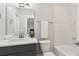 Bright bathroom with a marble tile shower and a grey vanity with a white countertop at 384 Blowing Fresh Dr, Charleston, SC 29492