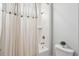 Bright bathroom featuring a shower with white marble, neutral shower curtain, and a small plant at 384 Blowing Fresh Dr, Charleston, SC 29492