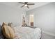 Bright bedroom features a ceiling fan, soft neutral walls, and a view into the ensuite bath at 384 Blowing Fresh Dr, Charleston, SC 29492