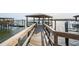 Waterfront dock with covered gazebo and Adirondack chairs, perfect for relaxing by the water at 384 Blowing Fresh Dr, Charleston, SC 29492