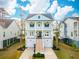 Beautiful two-story home with double front porches, a two-car garage, and lush landscaping at 384 Blowing Fresh Dr, Charleston, SC 29492