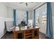 Bright home office with an elegant wooden desk, a comfortable chair, and natural light through french doors at 384 Blowing Fresh Dr, Charleston, SC 29492