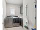 Convenient laundry room featuring modern appliances, a window for natural light, and ample storage at 384 Blowing Fresh Dr, Charleston, SC 29492