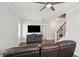 Modern living room with hardwood floors, a ceiling fan, a tv, and a comfortable leather couch at 384 Blowing Fresh Dr, Charleston, SC 29492