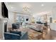 Bright living room boasts elegant chandelier, fireplace and access to the screened porch at 384 Blowing Fresh Dr, Charleston, SC 29492