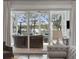 View of lake from screened in porch with comfortable seating area at 384 Blowing Fresh Dr, Charleston, SC 29492