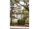 Scenic waterfront view from the property, showcasing lush trees, dock, and serene water, highlighting its natural beauty at 384 Blowing Fresh Dr, Charleston, SC 29492