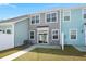 Townhome backyard featuring well-manicured grass, a patio, and stylish siding at 407 Stoneleigh Ln, Moncks Corner, SC 29461