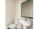 Clean and efficient half bathroom with a pedestal sink, toilet, and a simple mirror at 407 Stoneleigh Ln, Moncks Corner, SC 29461