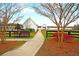 Charming white clubhouse and covered picnic area with lake views, accessible via a paved path at 407 Stoneleigh Ln, Moncks Corner, SC 29461
