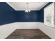 Dining room features elegant wainscoting, navy accent walls, and modern light fixture at 407 Stoneleigh Ln, Moncks Corner, SC 29461
