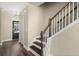 Inviting home foyer with a staircase, dark hardwood floors, and a dark front door at 407 Stoneleigh Ln, Moncks Corner, SC 29461