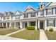 Inviting row of townhomes featuring colorful exteriors, well-kept lawns, and classic covered front porches at 407 Stoneleigh Ln, Moncks Corner, SC 29461