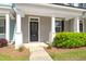 Welcoming front porch with classic columns, tidy landscaping, and a dark front door at 407 Stoneleigh Ln, Moncks Corner, SC 29461