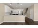 Spacious kitchen featuring marble counters, an island, modern stainless steel appliances, and wooden floors at 407 Stoneleigh Ln, Moncks Corner, SC 29461