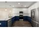 Modern kitchen showcases white and navy cabinets, marble countertops, and stainless steel appliances at 407 Stoneleigh Ln, Moncks Corner, SC 29461