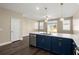 Spacious kitchen island with seating, marble countertop, sink, and stainless steel dishwasher at 407 Stoneleigh Ln, Moncks Corner, SC 29461