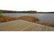 Lakeside wooden deck offers tranquil views of the water and surrounding natural landscape at 407 Stoneleigh Ln, Moncks Corner, SC 29461