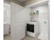 Laundry room with a washing machine, wire shelving, and adjacent bathroom at 407 Stoneleigh Ln, Moncks Corner, SC 29461