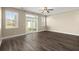 Open living room with dark laminate flooring, a ceiling fan, and sliding glass doors leading to outdoor space at 407 Stoneleigh Ln, Moncks Corner, SC 29461