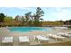 Large community swimming pool with lounge chairs offers a place for residents to relax and enjoy the outdoors at 407 Stoneleigh Ln, Moncks Corner, SC 29461