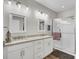 Bathroom with double sinks, granite countertops, and a glass-enclosed shower at 409 Klein St, Walterboro, SC 29488