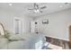 Bedroom with hardwood floors, a ceiling fan, a mounted TV, and neutral wall colors at 409 Klein St, Walterboro, SC 29488