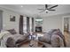 Open-concept living room with a TV, hardwood floors, neutral decor, and comfortable couches at 409 Klein St, Walterboro, SC 29488