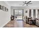 Bright living room with hardwood floors, a ceiling fan, sliding door to backyard, and ample seating at 409 Klein St, Walterboro, SC 29488