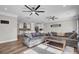 Spacious living room flows into a kitchen area, featuring hardwood floors and comfortable furnishings at 409 Klein St, Walterboro, SC 29488